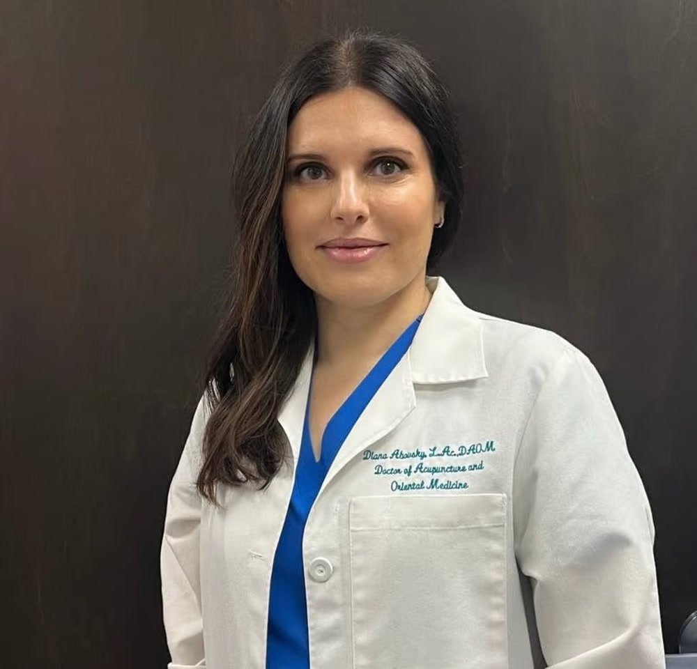 Dr. Diana Abovsky in her white coat, embroidered Diana Abovsky L.Ac, DAOM